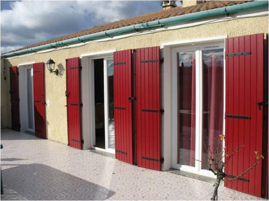 Volets rouges AFC à lames verticales sur portes-fenêtres blanches, façade Calvados.